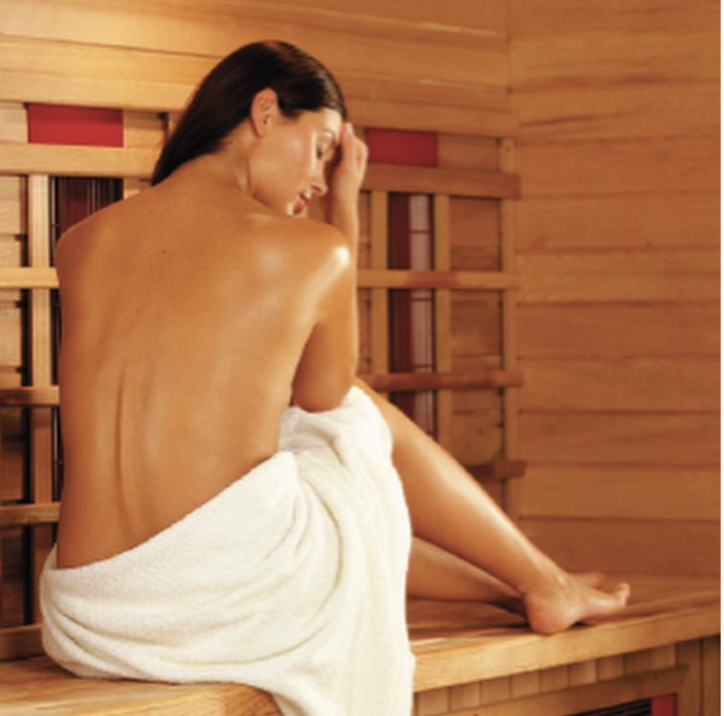 Client relaxing in cedar infrared sauna at Creative Chakra Spa orchard