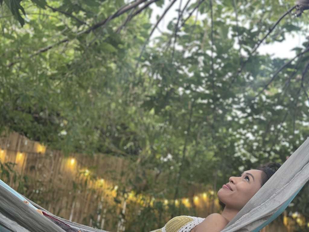 Practice the art of Forest Bathing laying on the hammock under the tree canopies
